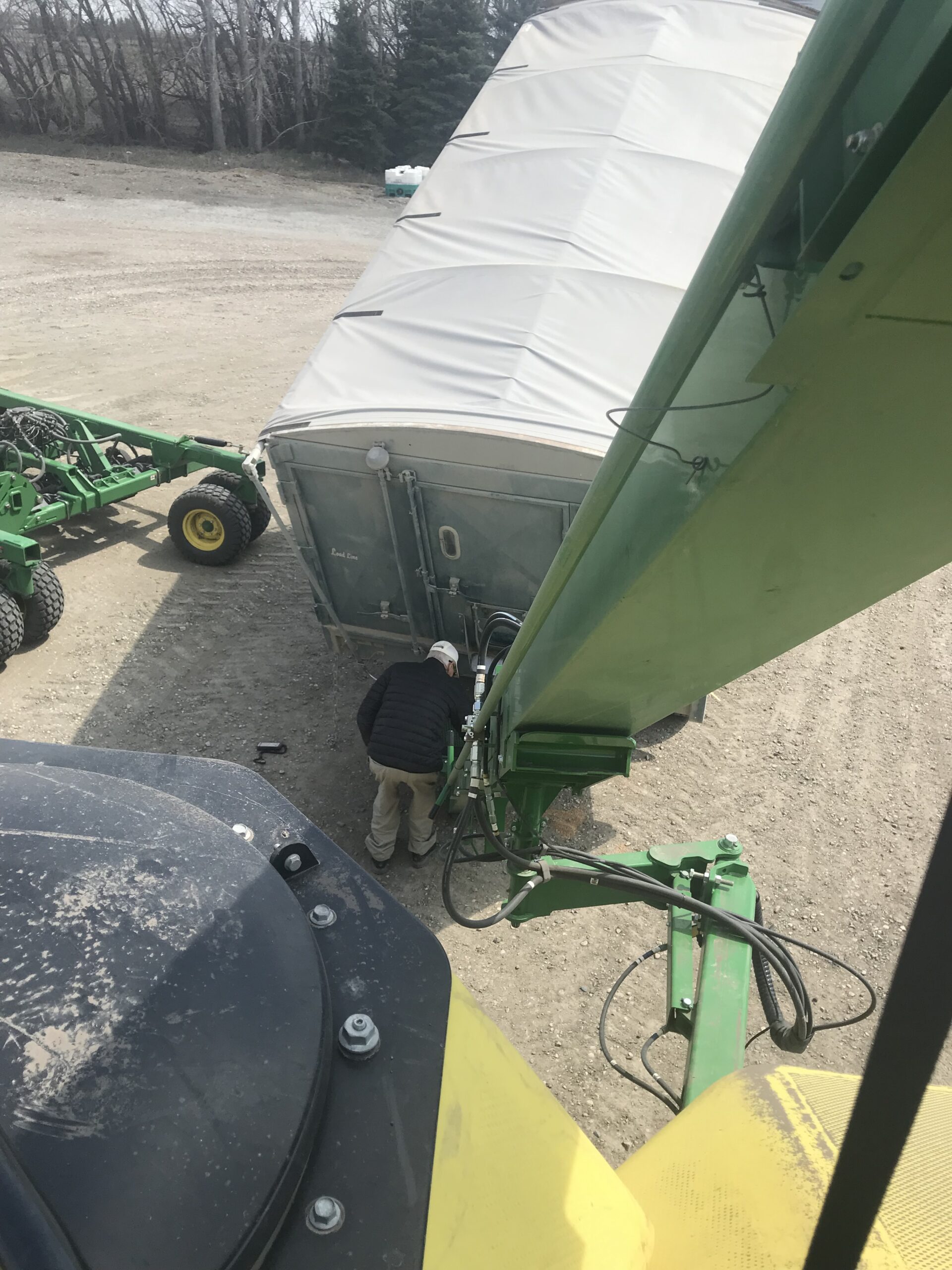 Farmer working at a bin connected to a truck